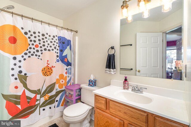 full bathroom featuring toilet, curtained shower, tile patterned flooring, and vanity
