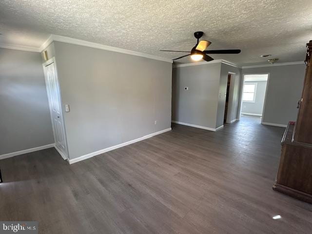 unfurnished room with baseboards, ornamental molding, a ceiling fan, and dark wood finished floors