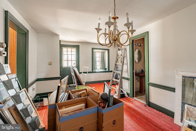 dining space featuring an inviting chandelier and baseboards
