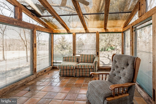 sunroom / solarium featuring plenty of natural light and vaulted ceiling