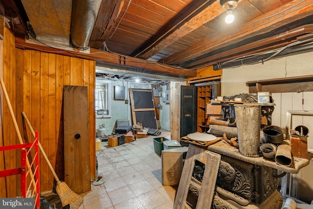 basement with tile patterned floors and electric panel
