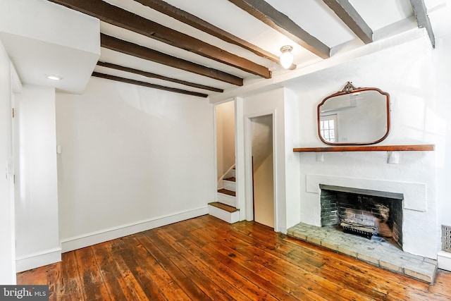 136 Carpenter St Unit A, Philadelphia, PA 19147 - unfurnished living room featuring wood-type flooring, a fireplace with raised hearth, baseboards, beamed ceiling, and stairway