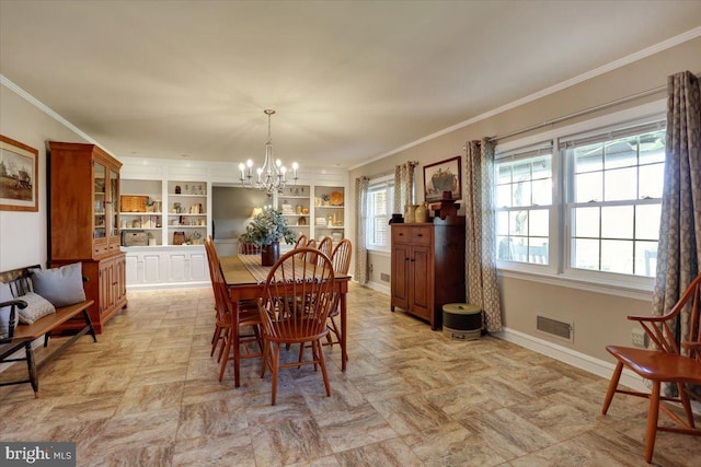 dining room featuring visible vents, crown molding, built in shelves, baseboards, and a notable chandelier