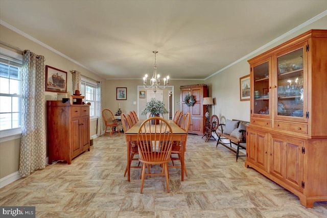 dining space with baseboards, an inviting chandelier, and ornamental molding