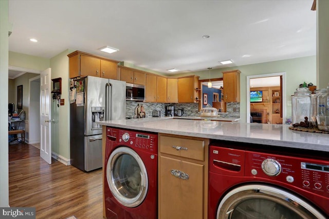 laundry room with washing machine and clothes dryer, recessed lighting, laundry area, and wood finished floors