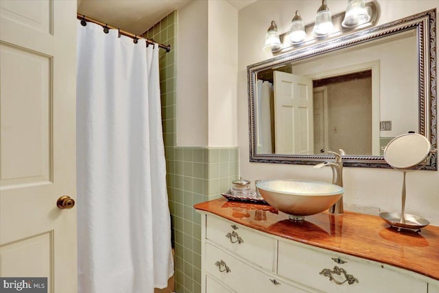 bathroom with tile walls and vanity