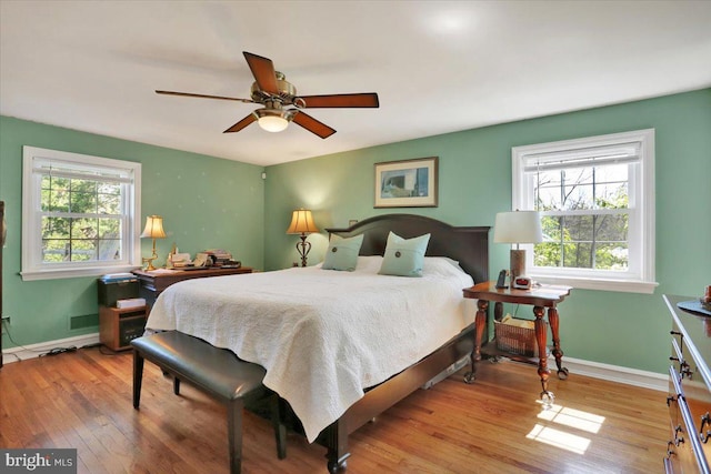 bedroom with baseboards, a ceiling fan, and wood finished floors