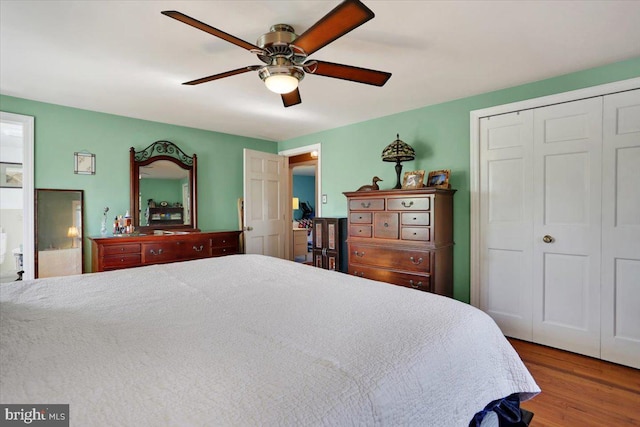 bedroom featuring a ceiling fan, a closet, and wood finished floors