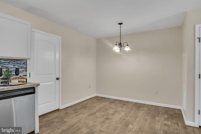 730 Farmwood Ln, Lebanon, PA 17042 - unfurnished dining area featuring a chandelier, light wood-style floors, and baseboards