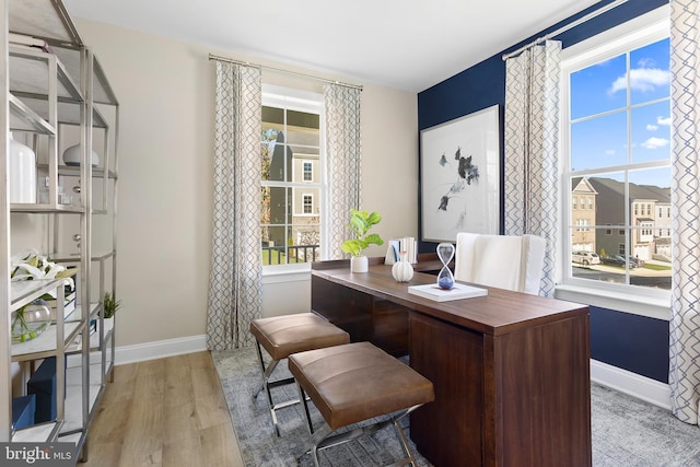 home office featuring baseboards and light wood-type flooring