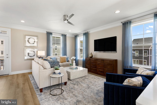 living room with ornamental molding, wood finished floors, baseboards, recessed lighting, and a ceiling fan