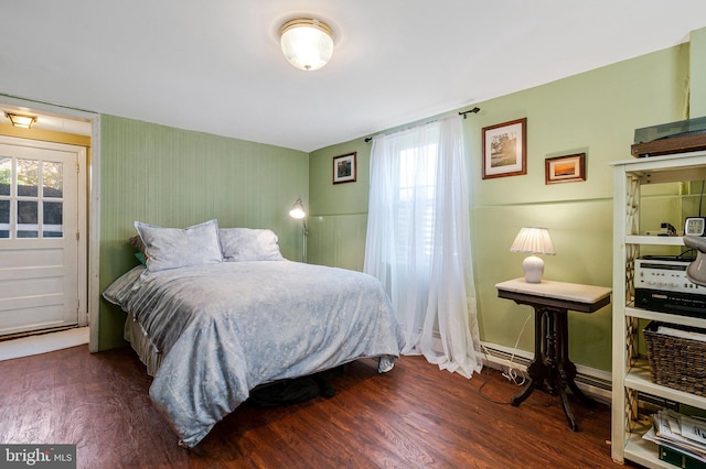 bedroom with baseboards and wood finished floors