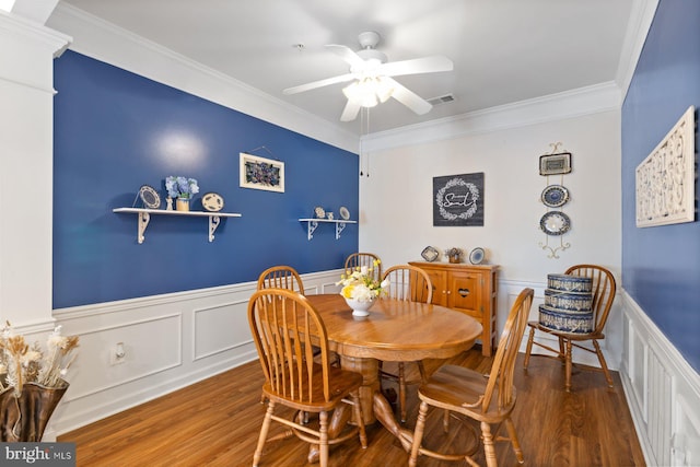 dining space with ornamental molding, ceiling fan, and wood finished floors