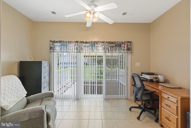 office space featuring light tile patterned flooring, a ceiling fan, and visible vents