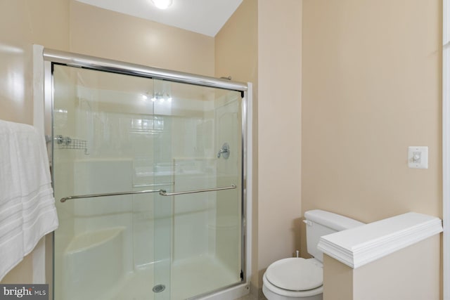 full bath with a stall shower and toilet