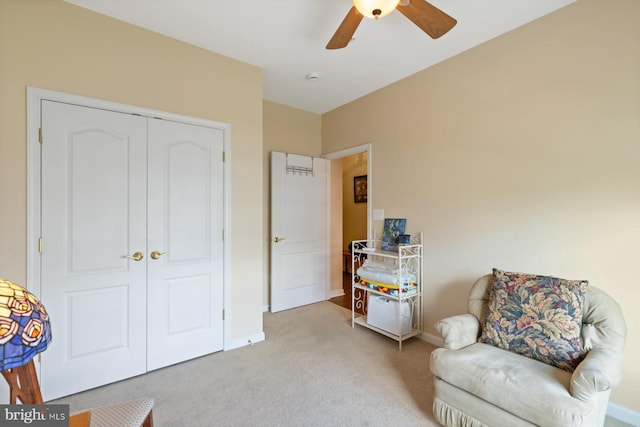 sitting room with light colored carpet, baseboards, and ceiling fan