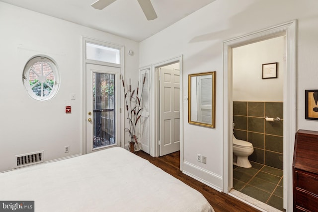 2308 Spruce St Unit 2310A, Philadelphia, PA 19103 - bedroom with visible vents, tile walls, ensuite bathroom, a ceiling fan, and dark wood finished floors