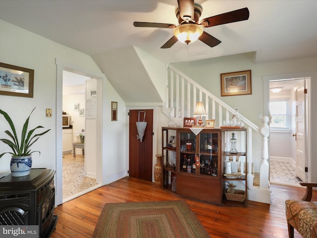 1691 Wakeman Mill Rd, Front Royal, VA 22630 - interior space featuring hardwood / wood-style floors, a wood stove, stairway, a ceiling fan, and baseboards