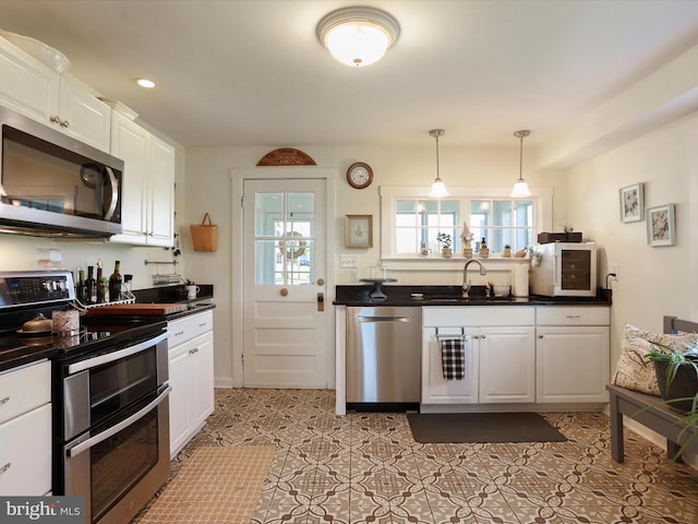 1691 Wakeman Mill Rd, Front Royal, VA 22630 - kitchen with white cabinetry, dark countertops, stainless steel appliances, and a sink
