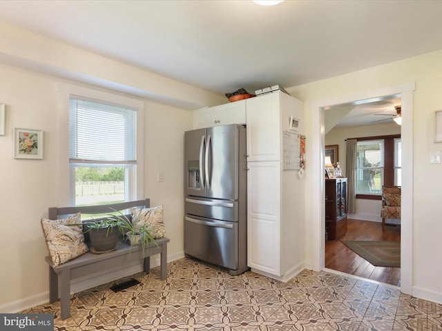 1691 Wakeman Mill Rd, Front Royal, VA 22630 - kitchen with ceiling fan, white cabinetry, stainless steel fridge, light tile patterned floors, and baseboards