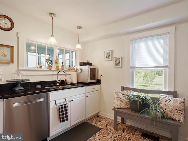 1691 Wakeman Mill Rd, Front Royal, VA 22630 - kitchen with a sink, dark countertops, pendant lighting, white cabinetry, and stainless steel dishwasher
