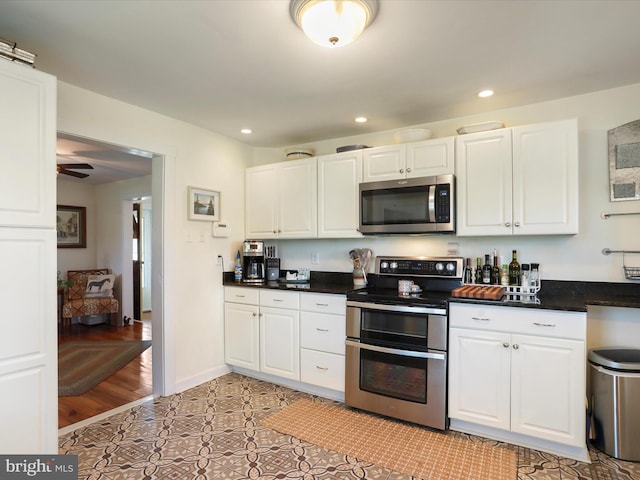 1691 Wakeman Mill Rd, Front Royal, VA 22630 - kitchen featuring stainless steel appliances, dark countertops, recessed lighting, and white cabinets