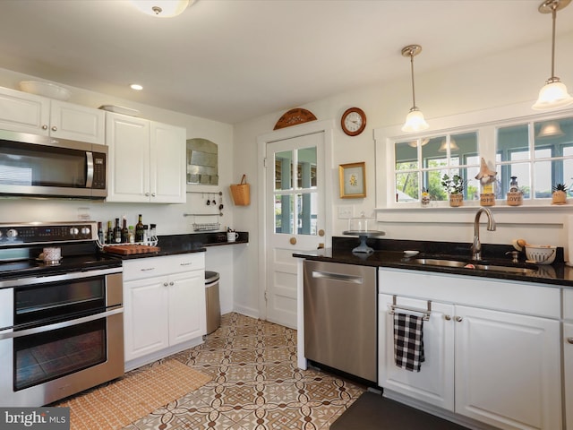 1691 Wakeman Mill Rd, Front Royal, VA 22630 - kitchen featuring a sink, stainless steel appliances, white cabinetry, and hanging light fixtures