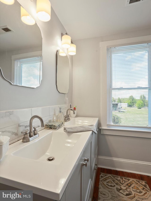 1691 Wakeman Mill Rd, Front Royal, VA 22630 - bathroom with double vanity, visible vents, wood finished floors, and a sink