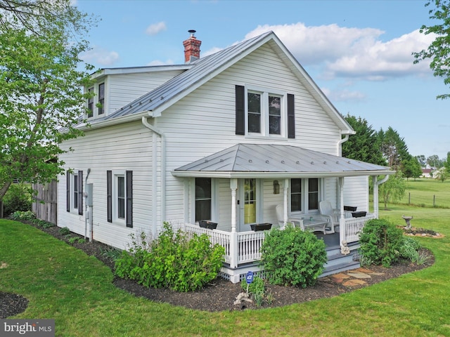 1691 Wakeman Mill Rd, Front Royal, VA 22630 - view of front of house featuring a chimney, a front yard, a porch, and metal roof