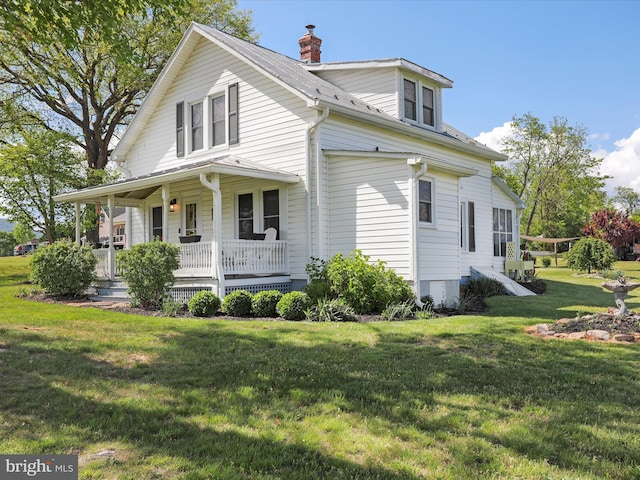 1691 Wakeman Mill Rd, Front Royal, VA 22630 - view of property exterior featuring a lawn, a chimney, and covered porch