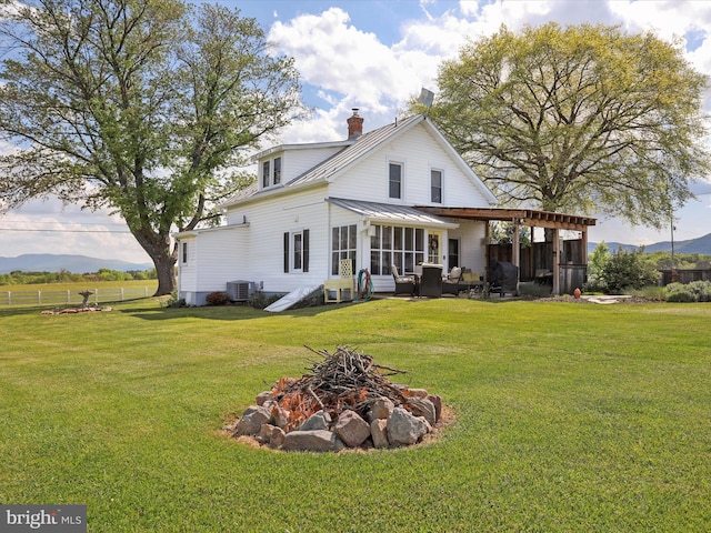 1691 Wakeman Mill Rd, Front Royal, VA 22630 - back of property with an outdoor fire pit, a sunroom, and a lawn