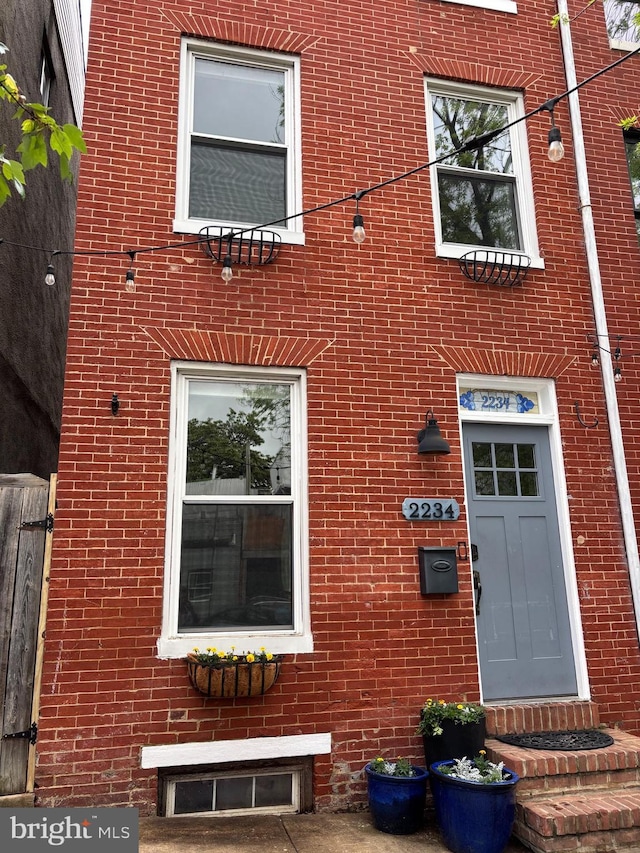 property entrance with brick siding