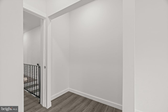 interior space featuring baseboards and dark wood finished floors
