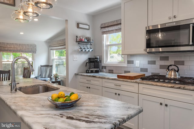 111 Linden Ave, Pasadena, MD 21122 - kitchen featuring plenty of natural light, a sink, backsplash, and stainless steel appliances