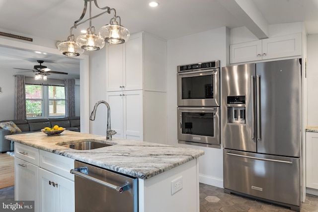 111 Linden Ave, Pasadena, MD 21122 - kitchen featuring a sink, white cabinets, light stone countertops, and stainless steel appliances