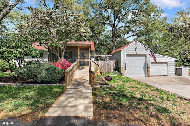 111 Linden Ave, Pasadena, MD 21122 - view of property hidden behind natural elements with fence, a detached garage, an outdoor structure, and a sunroom