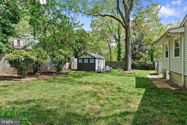 111 Linden Ave, Pasadena, MD 21122 - view of yard with an outdoor structure, a fenced backyard, and a storage unit