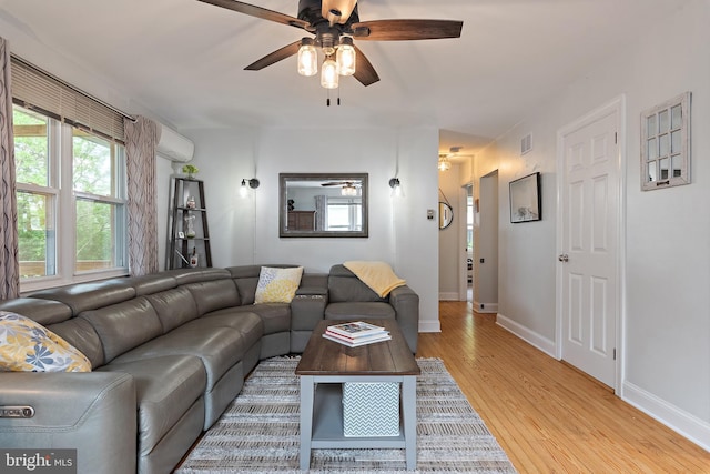 111 Linden Ave, Pasadena, MD 21122 - living room featuring an AC wall unit, light wood-style flooring, a ceiling fan, baseboards, and visible vents