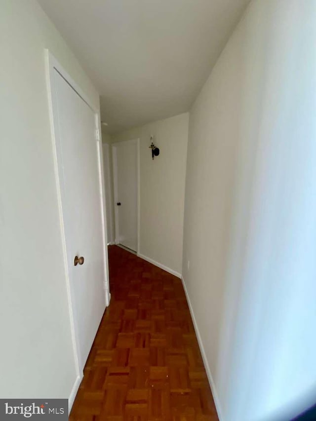 hall featuring baseboards