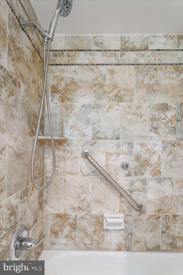 room details featuring shower / washtub combination