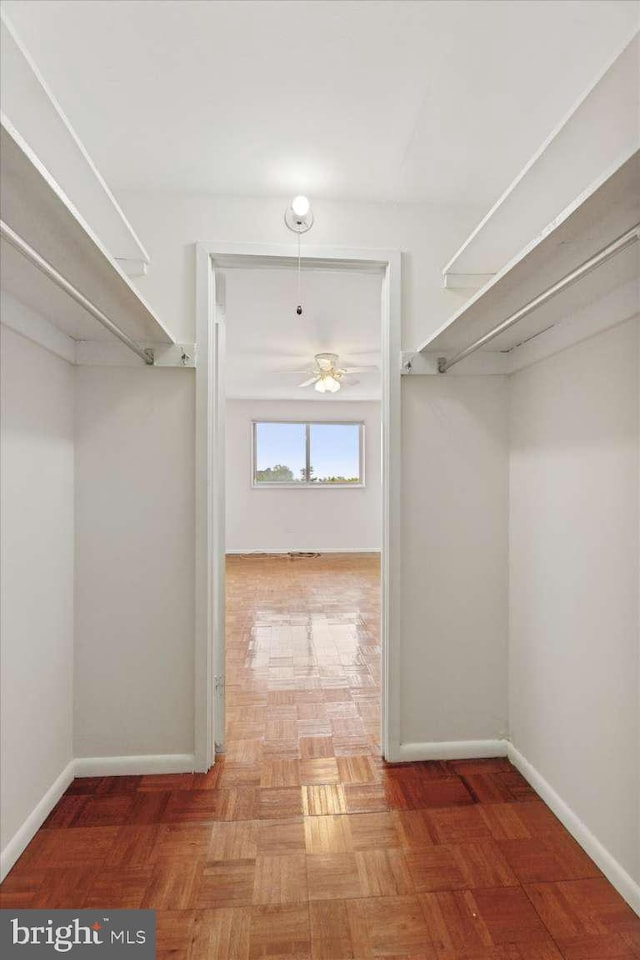 spacious closet with ceiling fan
