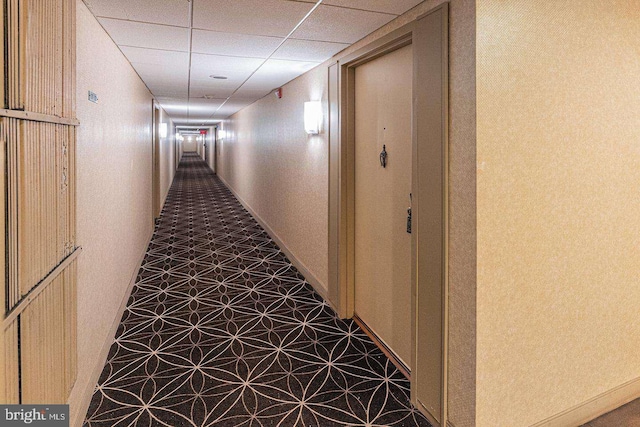 hallway featuring a paneled ceiling