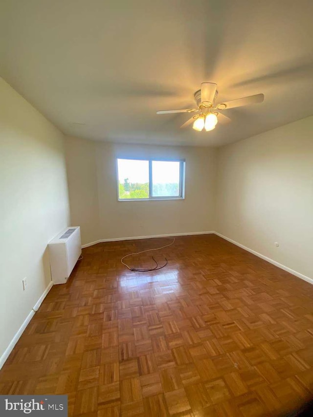 unfurnished room with baseboards and a ceiling fan