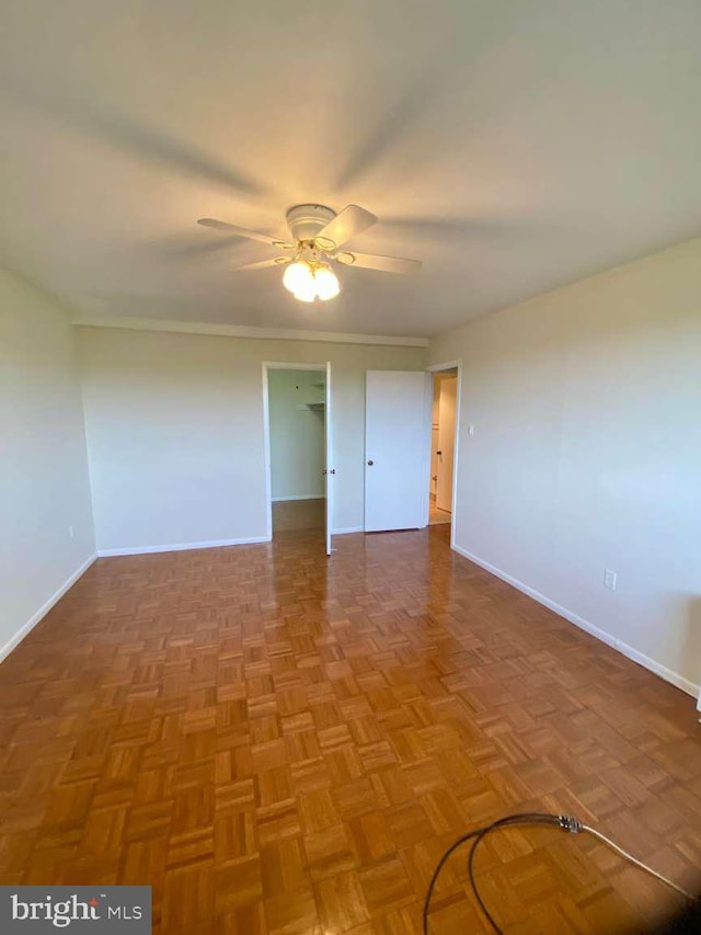 unfurnished room featuring baseboards and a ceiling fan