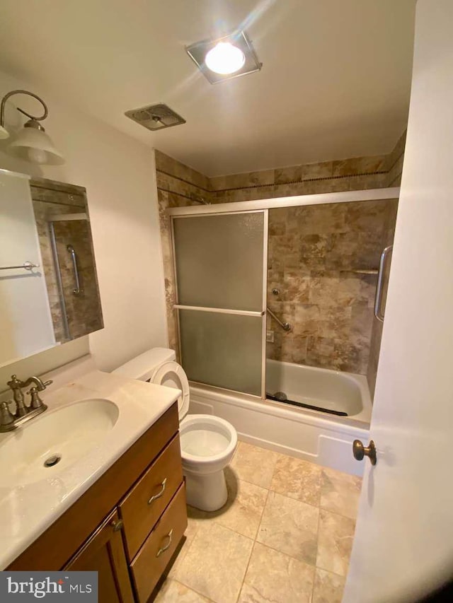 bathroom with shower / bath combination with glass door, toilet, visible vents, and vanity