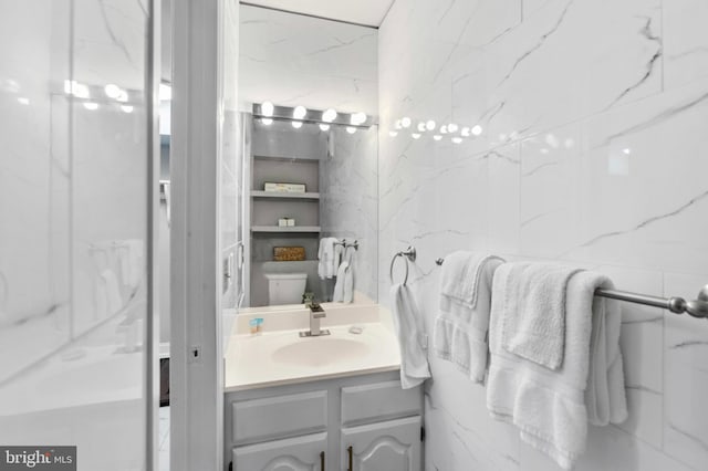bathroom featuring vanity and toilet