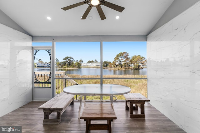 sunroom featuring recessed lighting, a water view, wood finished floors, and vaulted ceiling