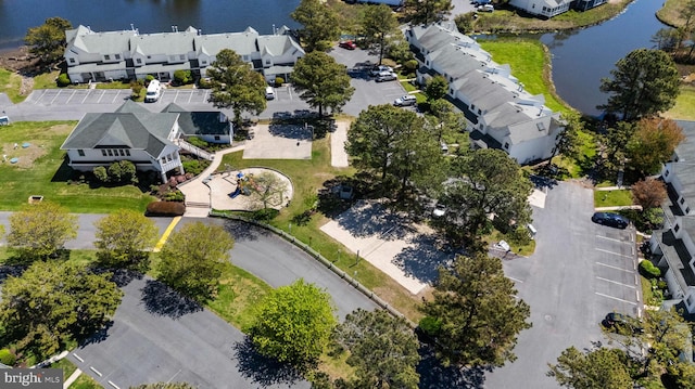 birds eye view of property featuring a water view and a residential view