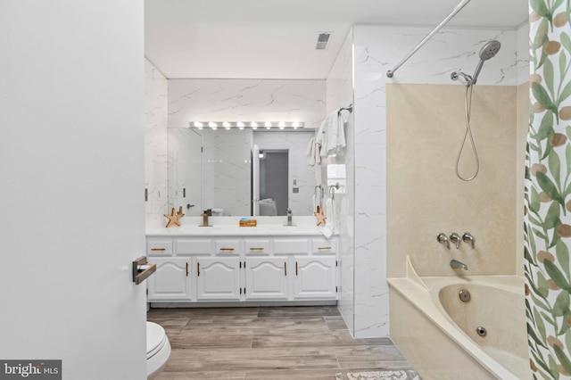 full bath with visible vents, shower / bath combination with curtain, wood finished floors, vanity, and toilet