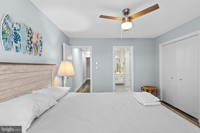 bedroom featuring a ceiling fan, a closet, wood finished floors, and connected bathroom
